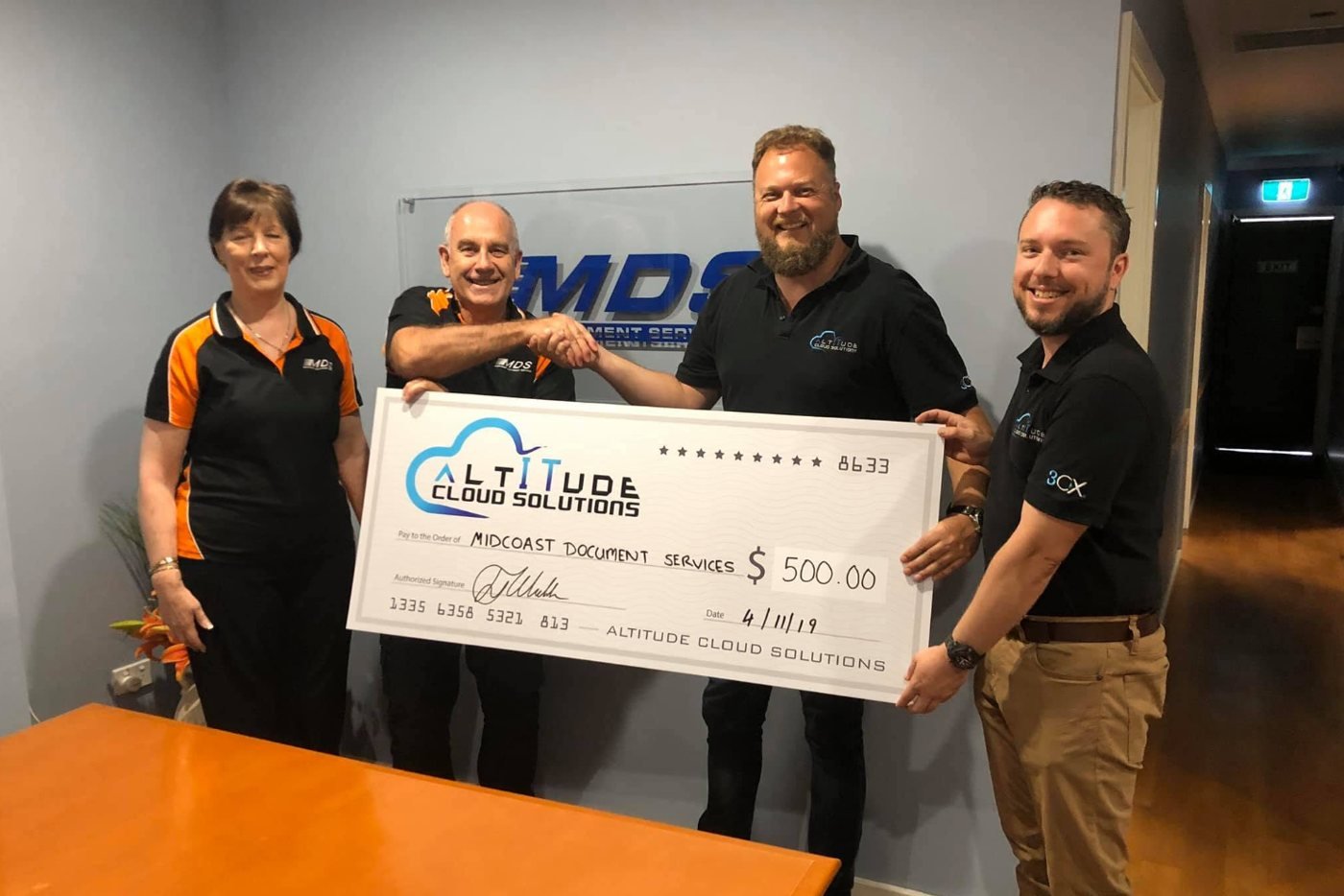 The ACS team presenting a $500 referral cheque to MidCoast Document Services